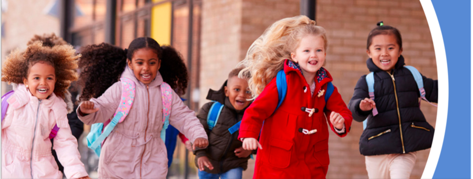 Group of children aged 5 to 9 running with school bags on their backs