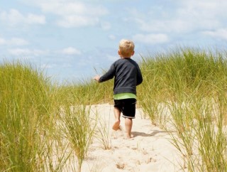 Toddler running on the beach